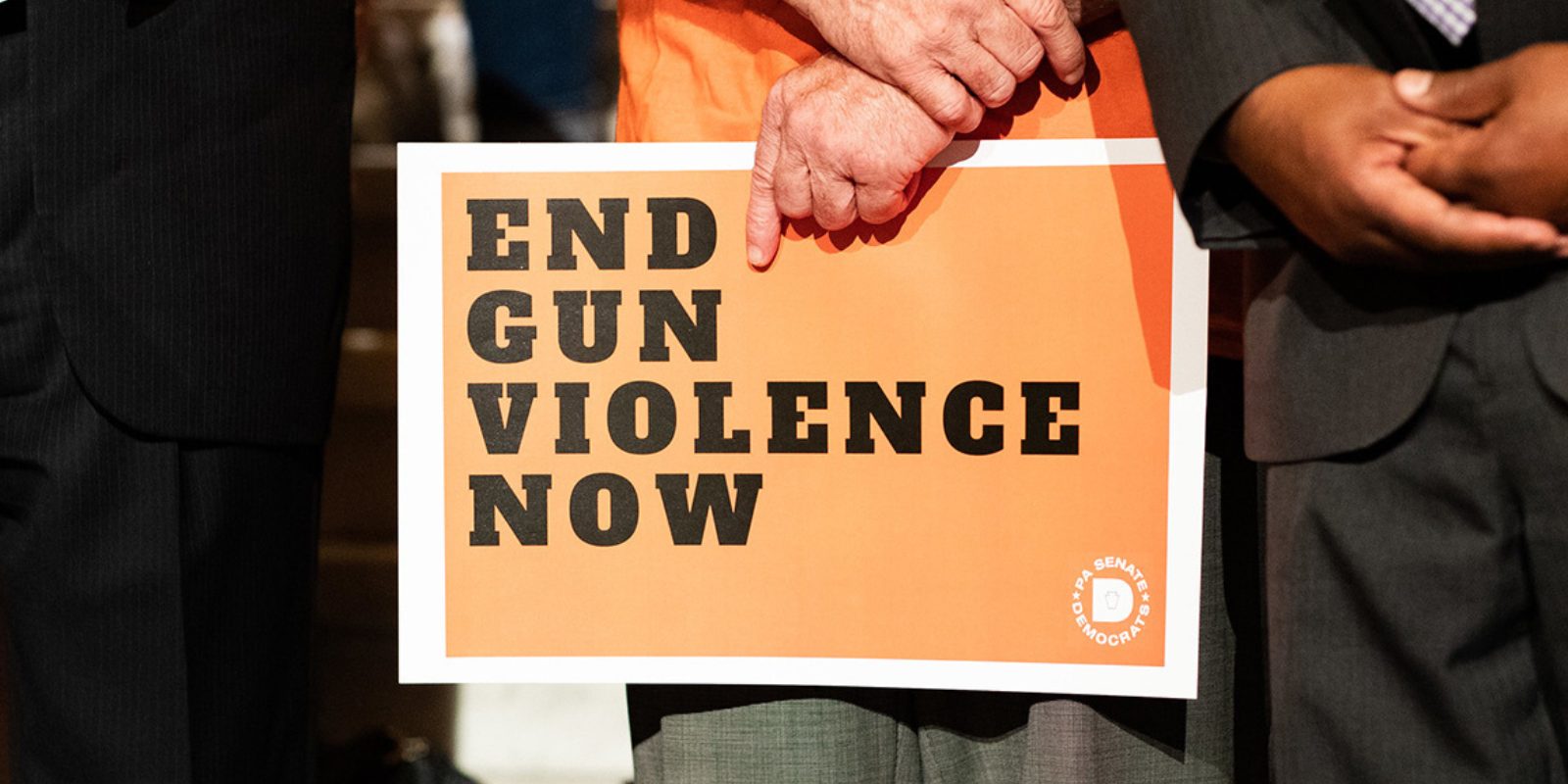 A sign reading "end gun violence now"