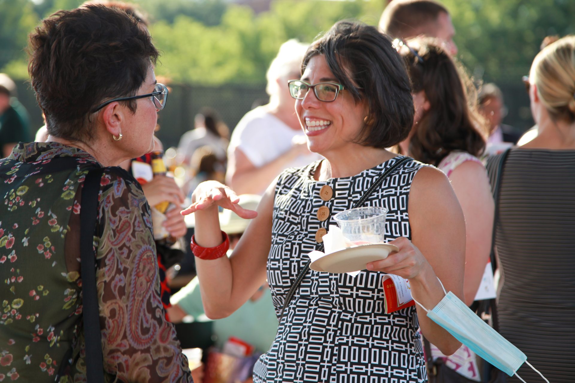 Two women smile at each other, chatting during the event